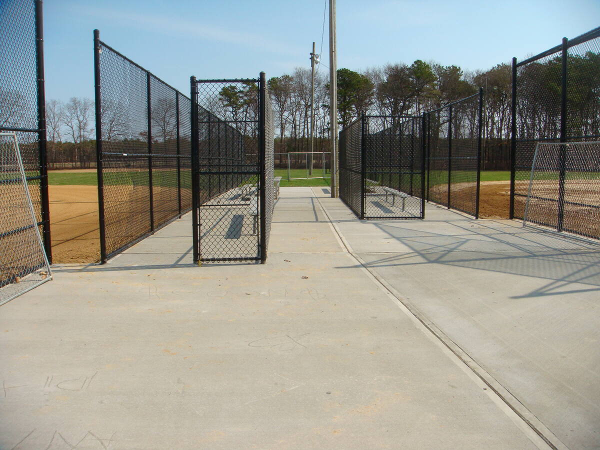 Chain link fencing, gates and concrete at a ballfield complex